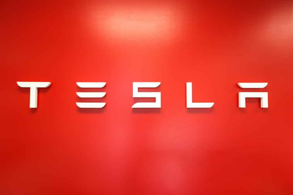 TESLA sign on the wall inside a Tesla store.